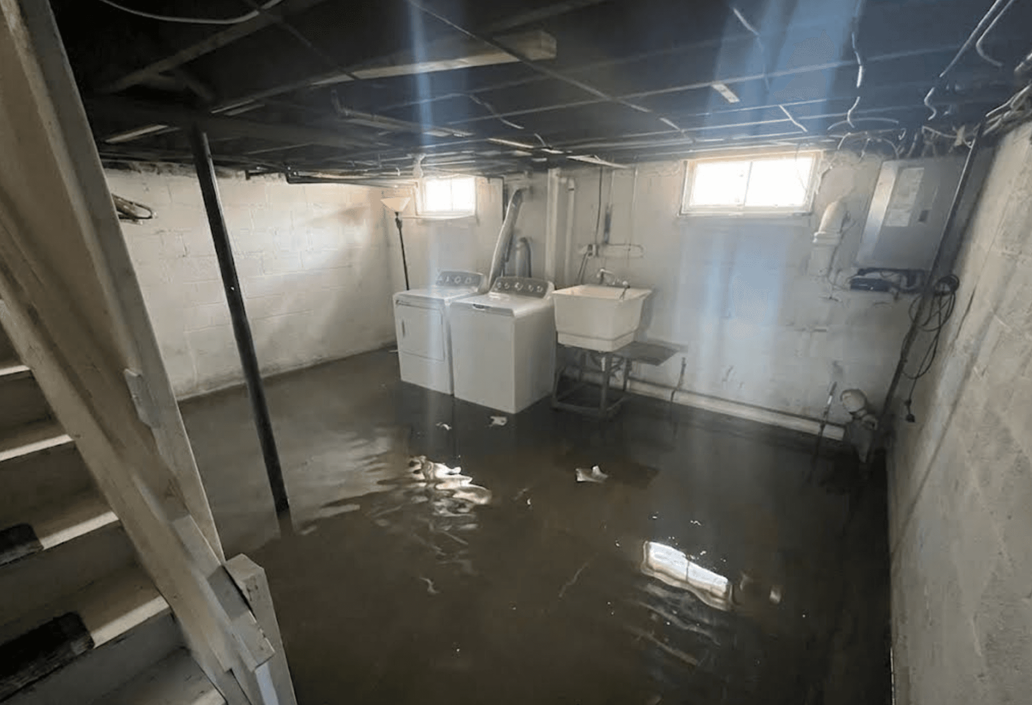 Flooded basement after Six HVAC pump replacement in Hamilton NJ — standing water covering entire floor