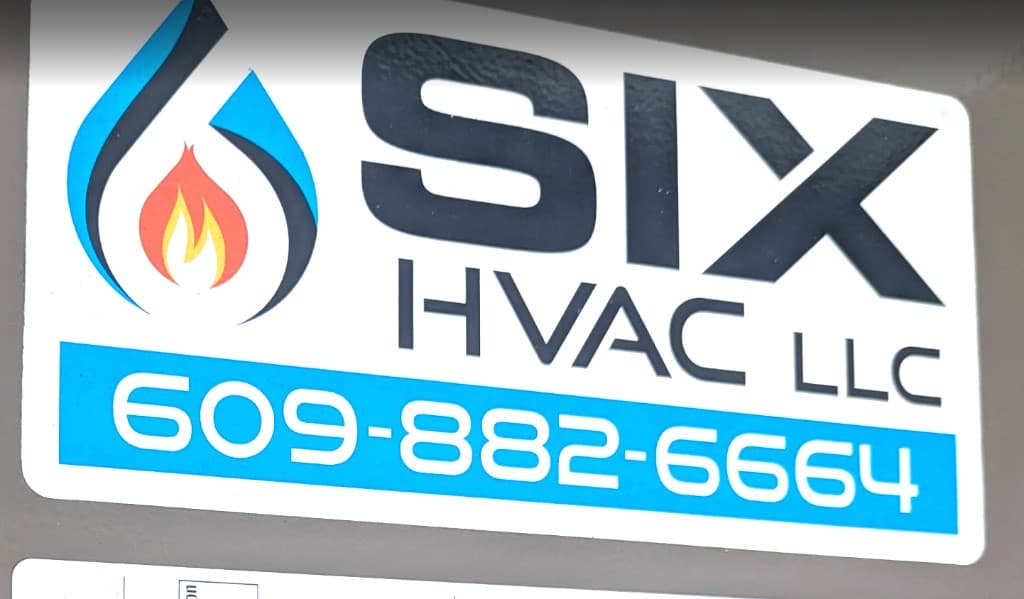 Six HVAC LLC sticker on AC unit showing business name and phone number 609-882-6664 — Princeton NJ HVAC contractor